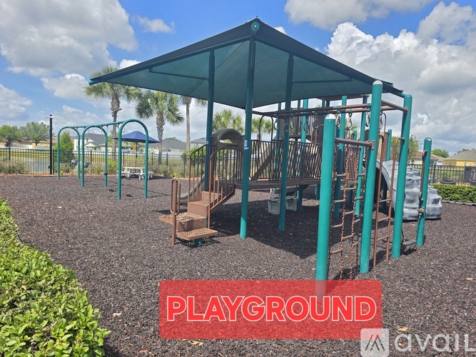 A playground with a green canopy and a slide.