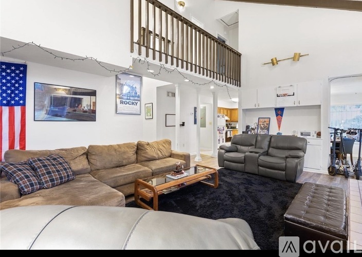 A living room with a couch, a chair, and a coffee table.