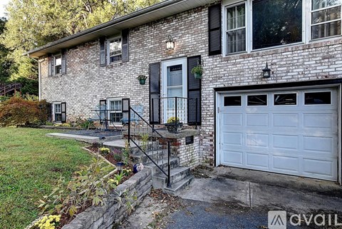 A house with a white garage door and a black door.