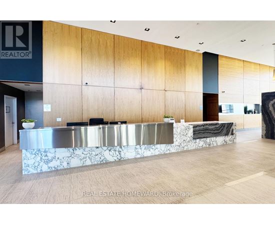 A reception area with a marble counter and wooden panels.