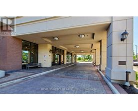 A long hallway with a Realosophy Realty Inc. sign at the end.