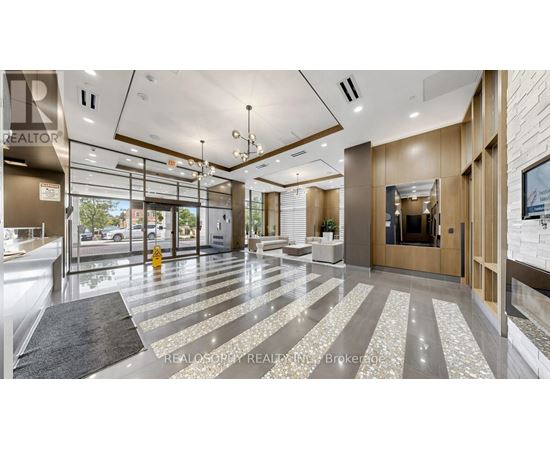 A modern office lobby with a glass wall and a reception desk.