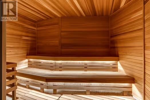 A wooden sauna with benches and a light source.