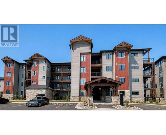 A large apartment complex with a car parked in front.