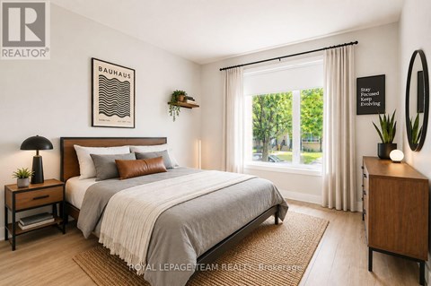 A well-lit bedroom with a large bed and a poster on the wall.