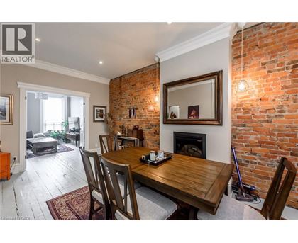 A dining room with a wooden table and chairs.