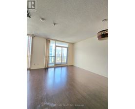 A room with wooden floors and a large window.