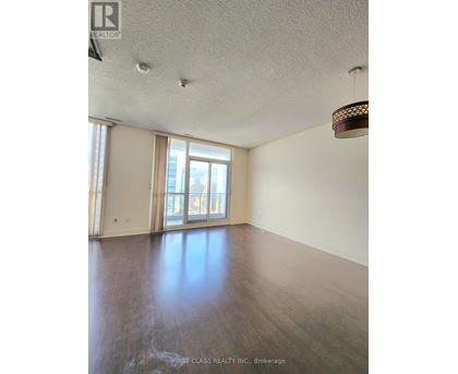 A room with wooden floors and a large window.