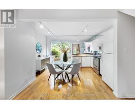 A modern kitchen with a dining table set for four.