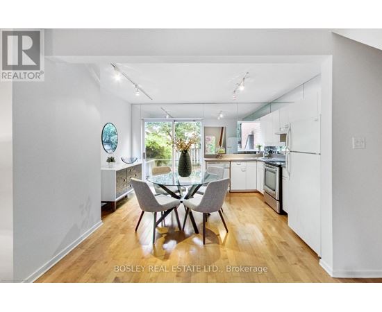 A modern kitchen with a dining table set for four.
