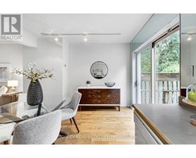 A modern dining room with a glass table and chairs.