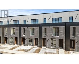 A modern building with a grey facade and black accents.