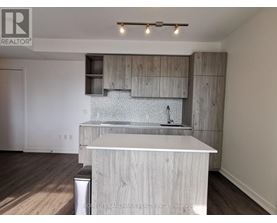 A modern kitchen with wooden cabinets and a white island.