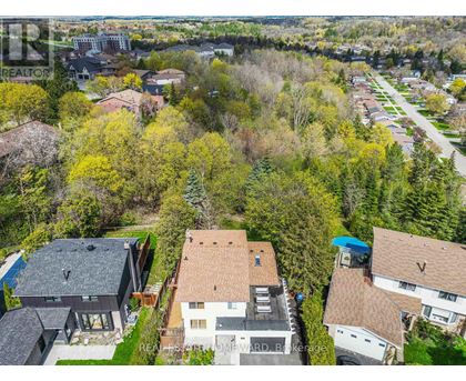 A bird's eye view of a residential area with houses and trees.