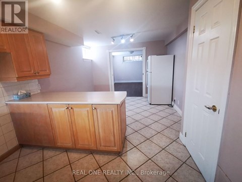 A kitchen with wooden cabinets and a white refrigerator.