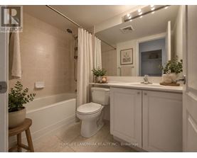 A white bathroom with a toilet, sink, and bathtub.