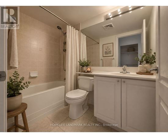 A white bathroom with a toilet, sink, and bathtub.