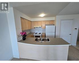 A kitchen with a sink, stove, and refrigerator.