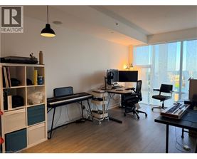 A room with a desk, chair, and computer setup.