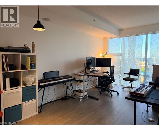 A room with a desk, chair, and computer setup.