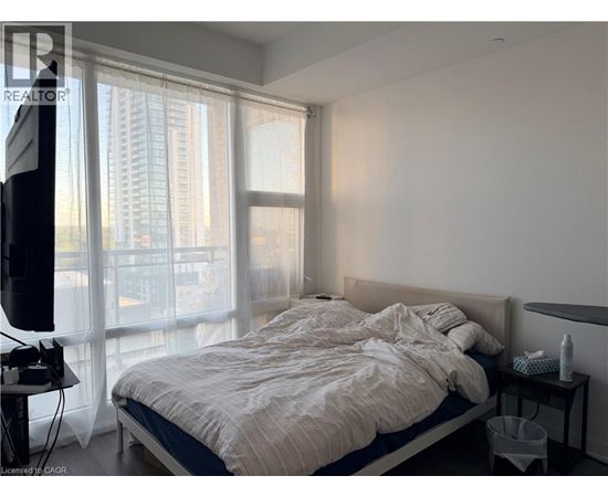 A bedroom with a large bed and a television.