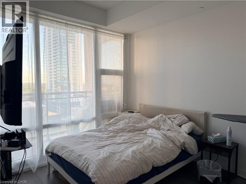 A bedroom with a large bed and a television.