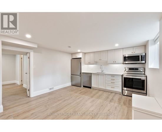 A kitchen with white cabinets and stainless steel appliances.