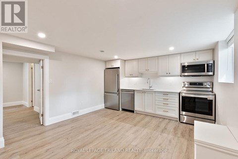 A kitchen with white cabinets and stainless steel appliances.