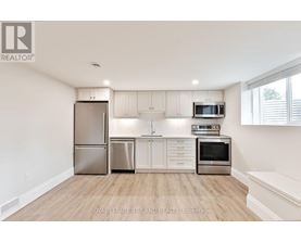 A kitchen with white cabinets and stainless steel appliances.