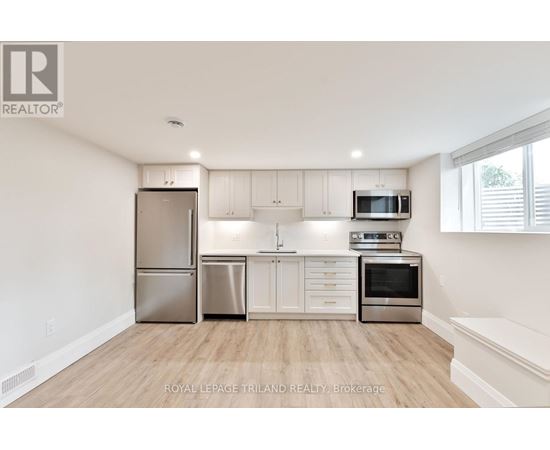 A kitchen with white cabinets and stainless steel appliances.