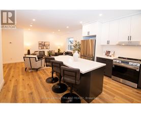 A modern kitchen with a large island and stainless steel appliances.