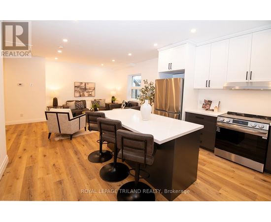 A modern kitchen with a large island and stainless steel appliances.