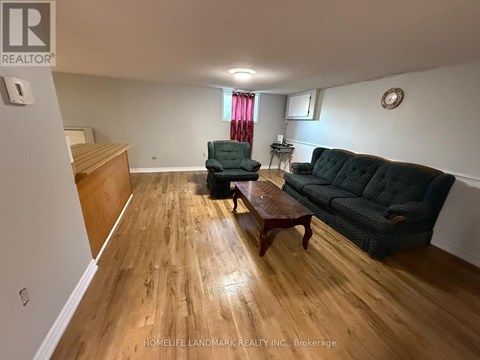 A living room with a couch, chair, and coffee table.