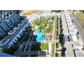 A bird's eye view of a residential area with houses and a swimming pool.
