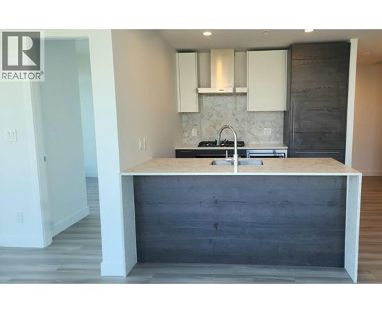 A kitchen with a wooden island and white cabinets.