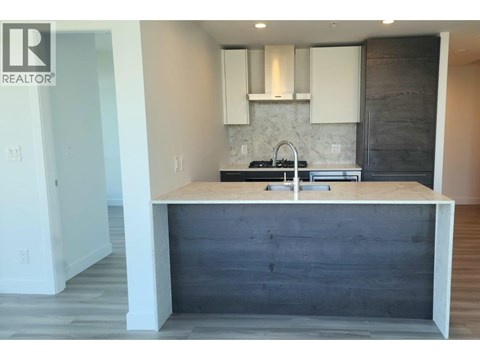 A kitchen with a wooden island and white cabinets.