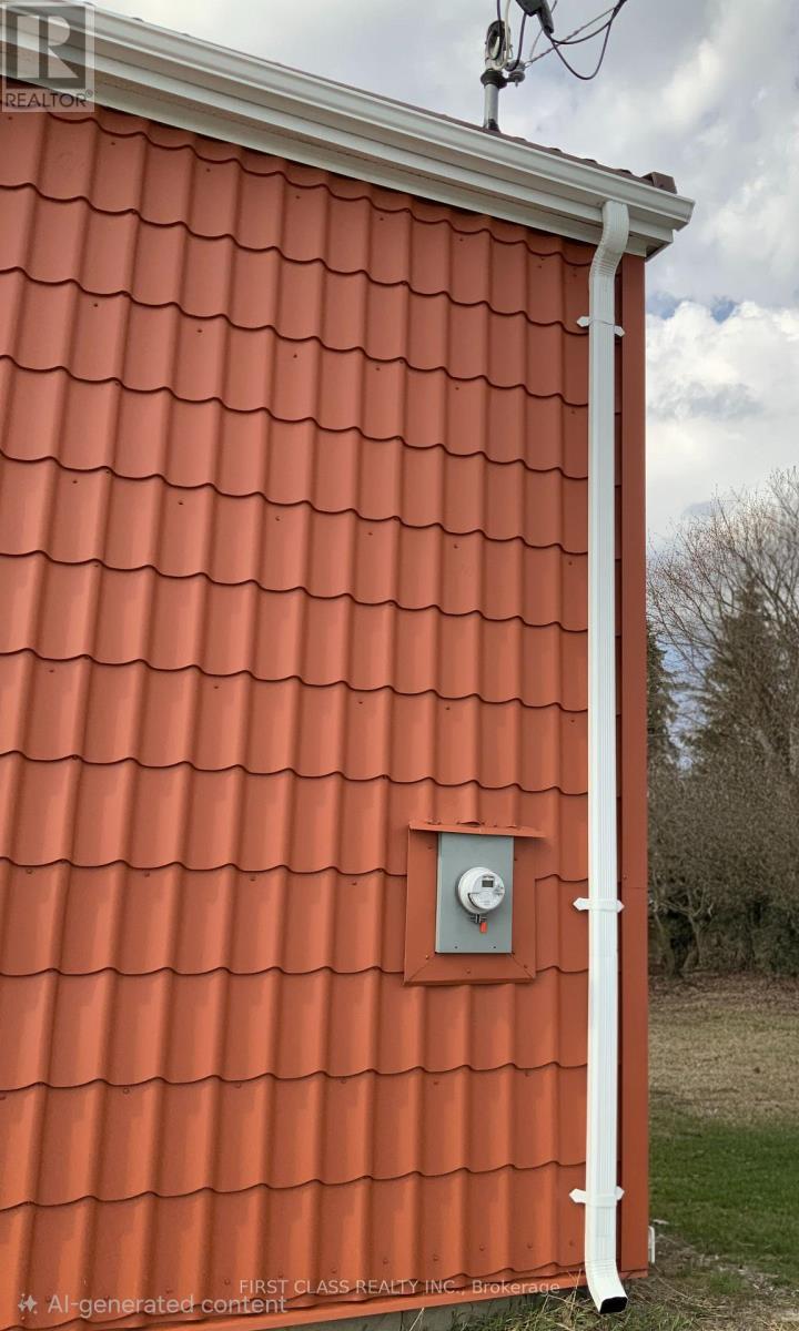 A red roof with a white pipe and a vent.