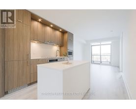 A modern kitchen with wooden cabinets and a white island.