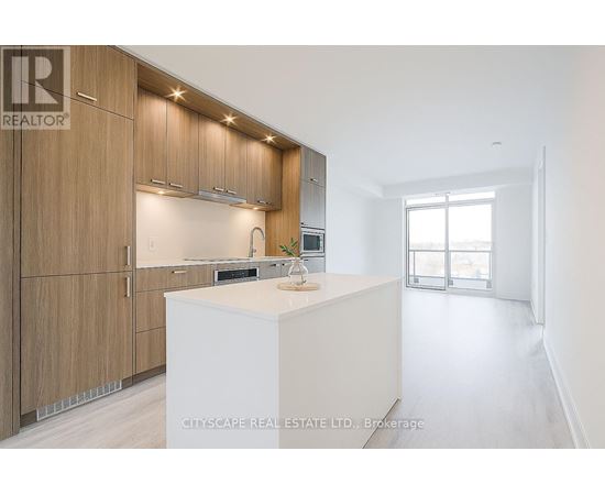 A modern kitchen with wooden cabinets and a white island.