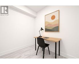 A room with a desk, chair, and a painting on the wall.