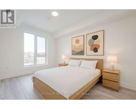 A bedroom with a large bed, two nightstands, and a painting on the wall.