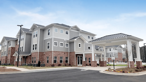 A large, modern building with a mix of brick and siding exterior.