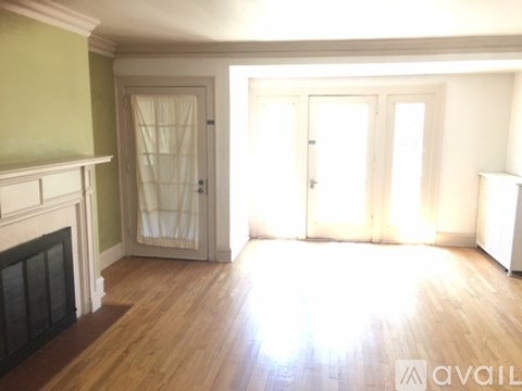 A room with a fireplace and wooden floors.