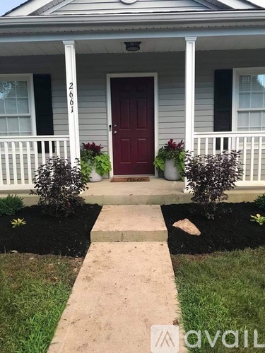 A house with a red door and a white porch.