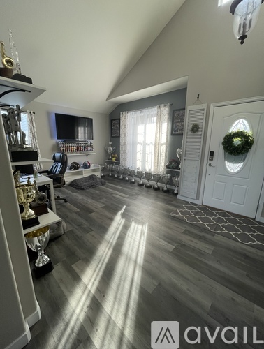 A room with a wooden floor and a white door.