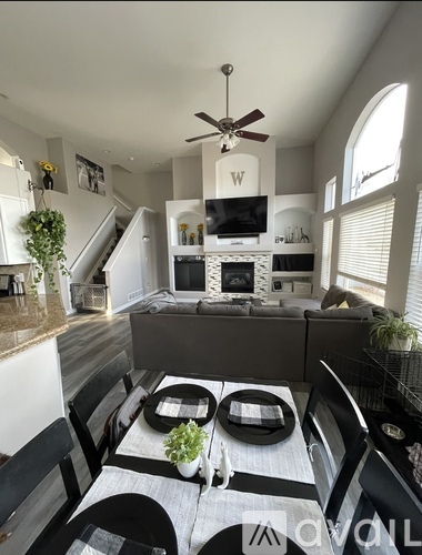 A modern kitchen with a dining table set for two.