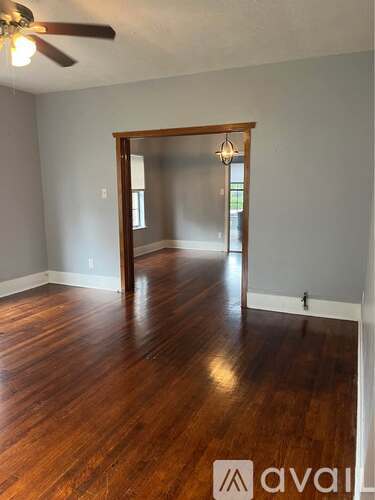 A room with wooden floors and a ceiling fan.
