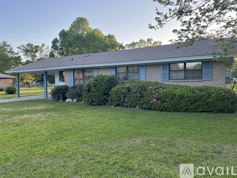 A house with a well-maintained lawn in front.