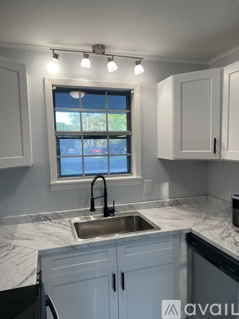 A kitchen with a window above the sink.