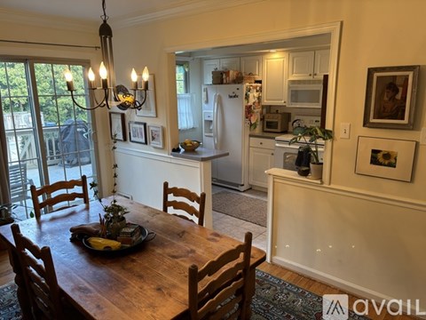 A dining room with a wooden table and chairs.